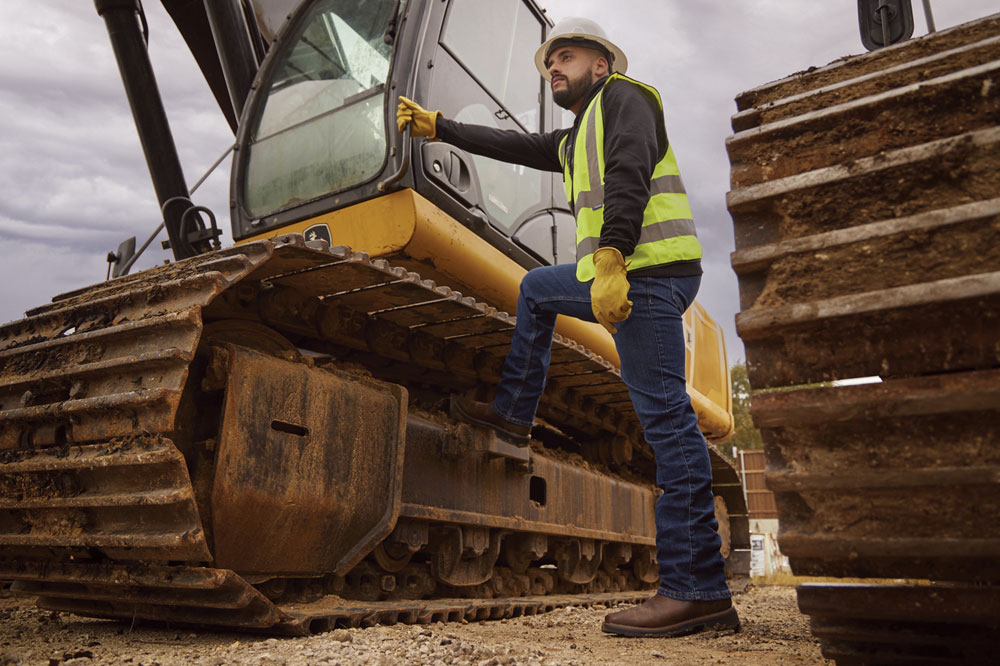 A photo montage of a construction worker wearing Justin work boots on a job site.